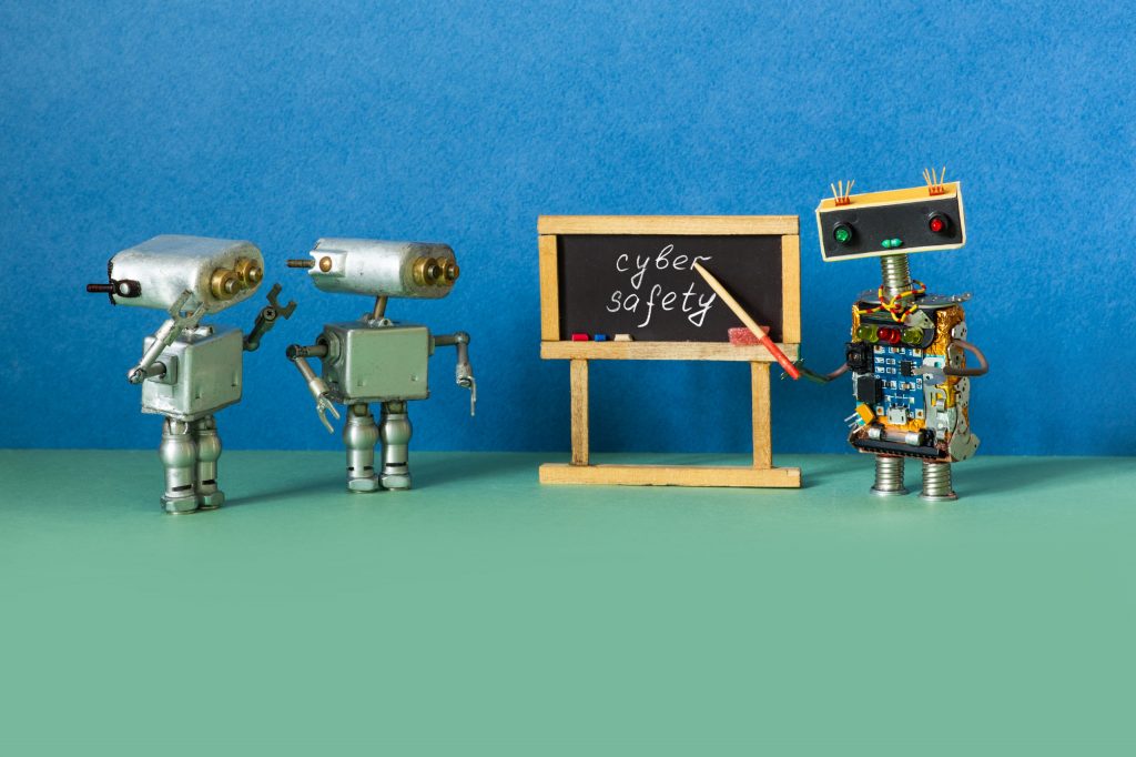 a group of robots next to a sign