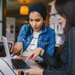 a person and a child using a laptop